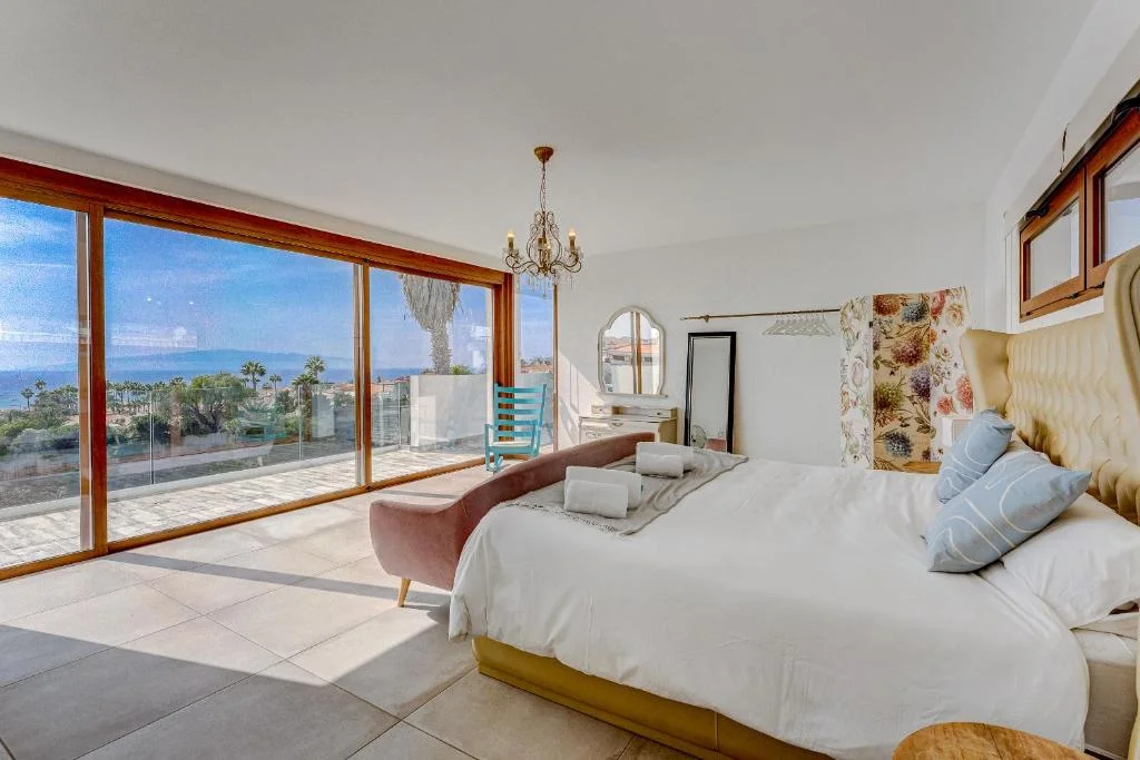 Bedroom with large windows and views of the outdoors